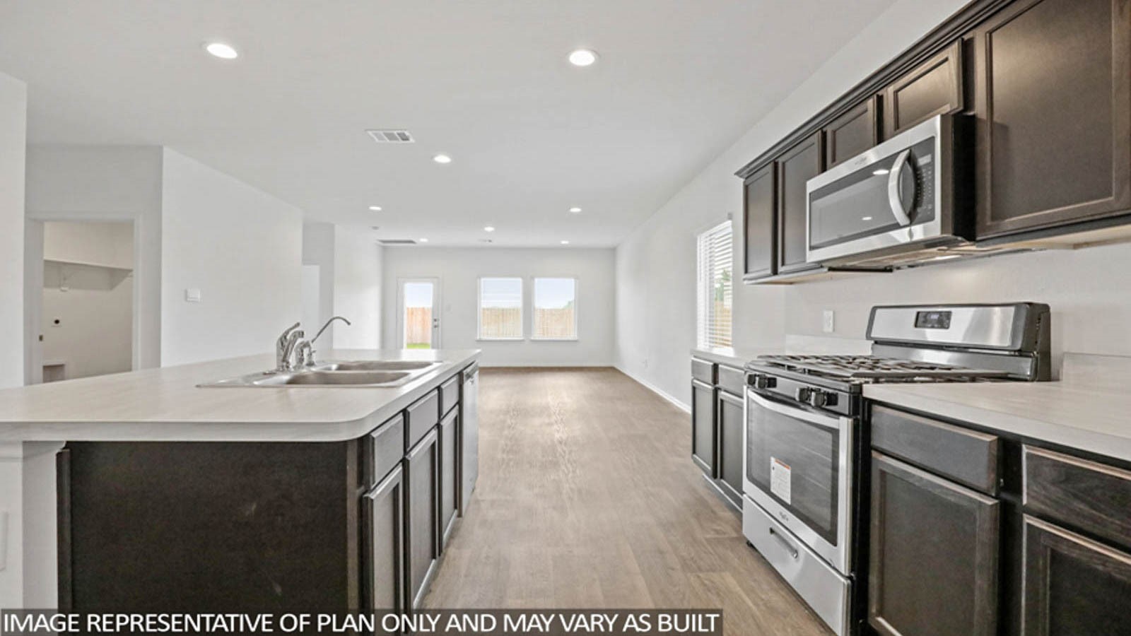 23780 Patchouli Terrace Drive Splendora, TX 77372 - Photo 2 of 25 a kitchen with stainless steel appliances granite countertop a sink stove and microwave