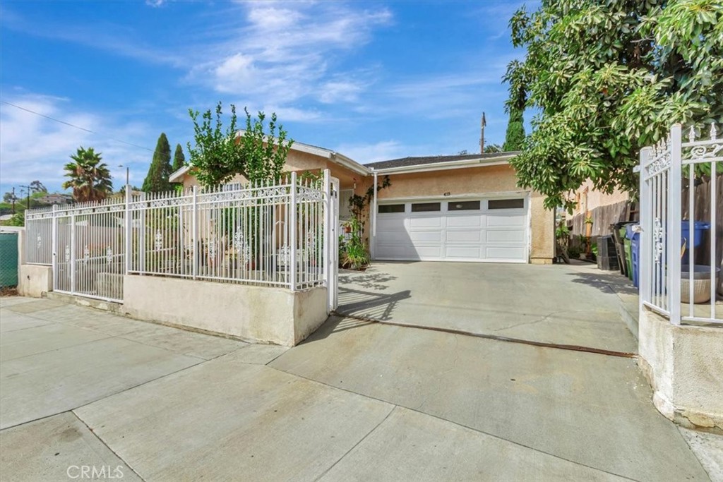 4133 North Mission Road Los Angeles, CA 90032 - Photo 11 of 40 a view of a house with a backyard and a garage