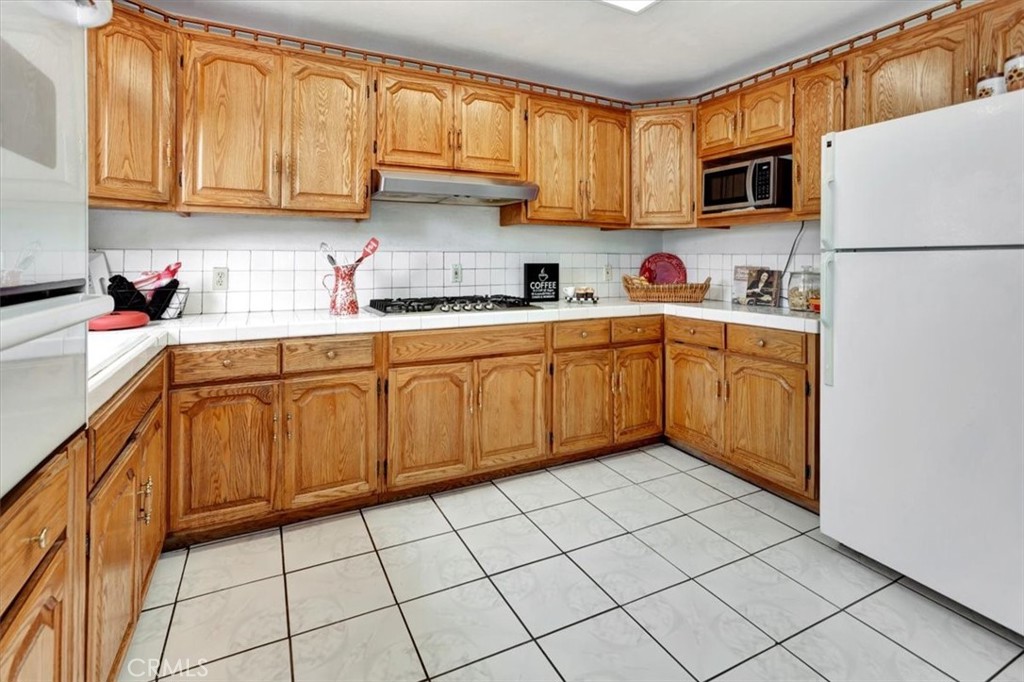 4133 North Mission Road Los Angeles, CA 90032 - Photo 14 of 40 a kitchen with stainless steel appliances granite countertop a refrigerator sink and cabinets
