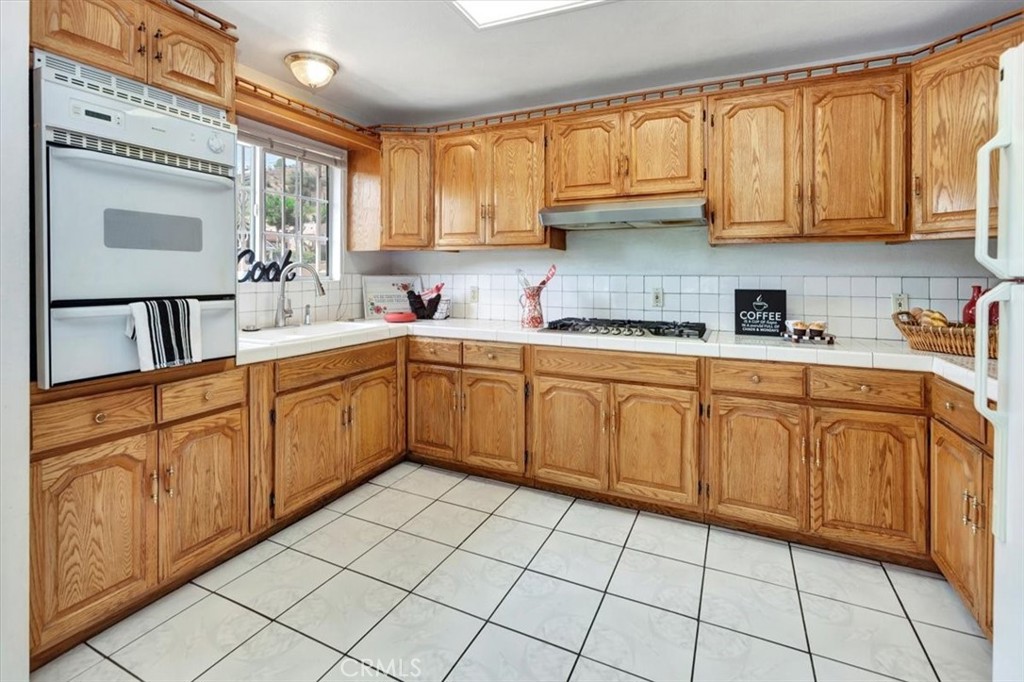 4133 North Mission Road Los Angeles, CA 90032 - Photo 9 of 40 a kitchen with stainless steel appliances granite countertop a sink and cabinets