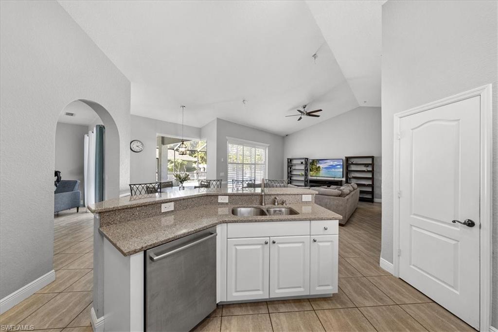 297 Sawgrass Court Naples, FL 34110 - Photo 14 of 31 a kitchen with a sink stove and refrigerator