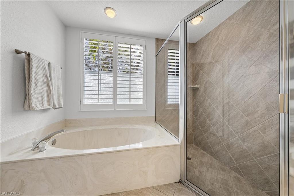 297 Sawgrass Court Naples, FL 34110 - Photo 20 of 31 a white bath tub sitting next to a window