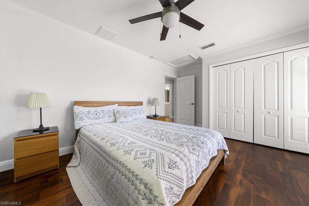 297 Sawgrass Court Naples, FL 34110 - Photo 24 of 31 a bedroom with a bed and a mirror