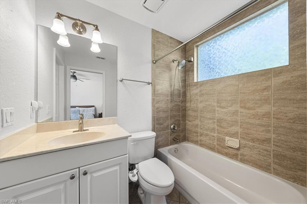 297 Sawgrass Court Naples, FL 34110 - Photo 25 of 31 a bathroom with a sink a toilet and a bathtub