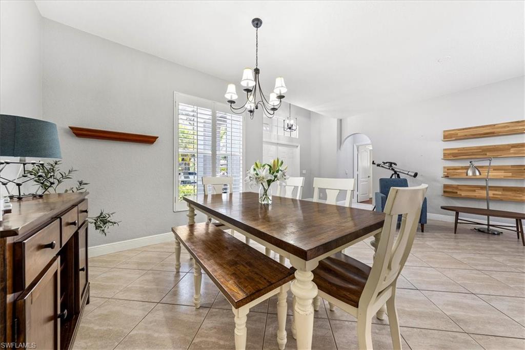 297 Sawgrass Court Naples, FL 34110 - Photo 7 of 31 a dining room with furniture and window