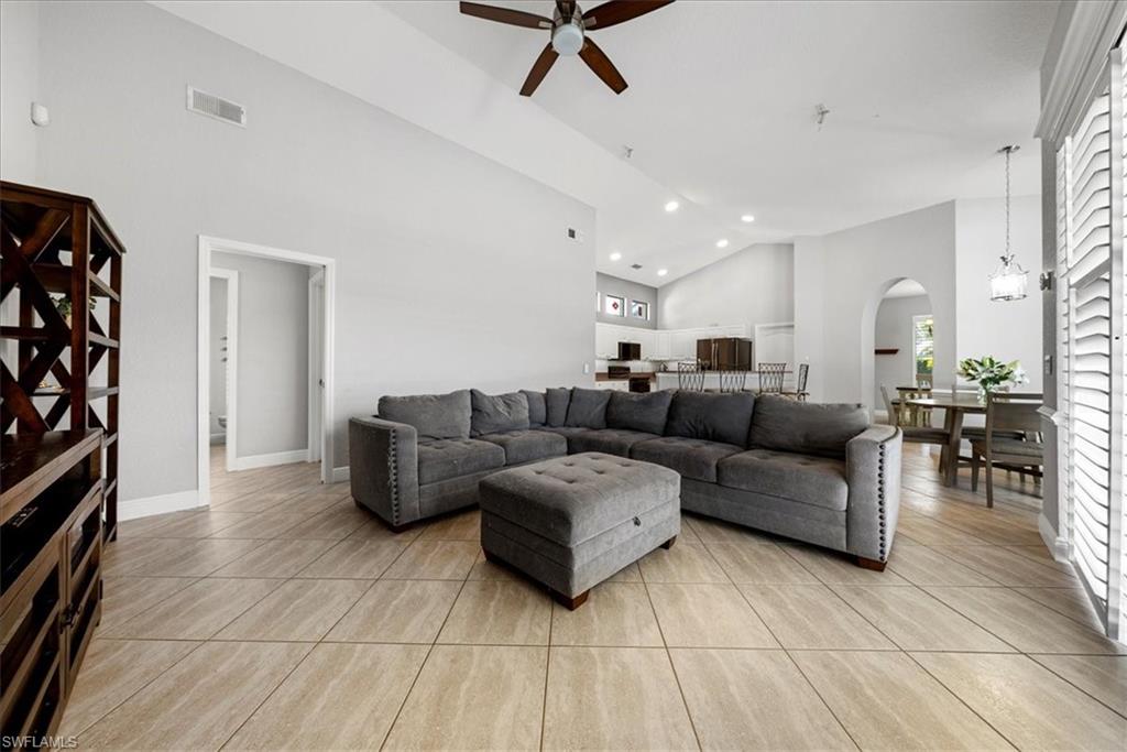 297 Sawgrass Court Naples, FL 34110 - Photo 8 of 31 a living room with furniture and a flat screen tv