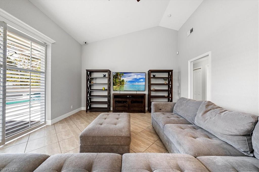 297 Sawgrass Court Naples, FL 34110 - Photo 10 of 31 a living room with furniture and a flat screen tv