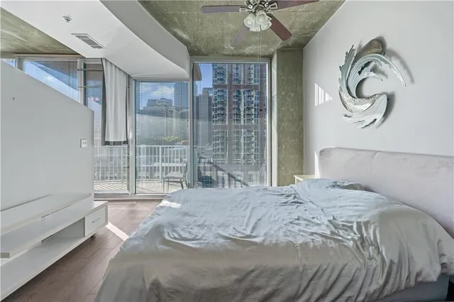 a bedroom with a bed and a large window