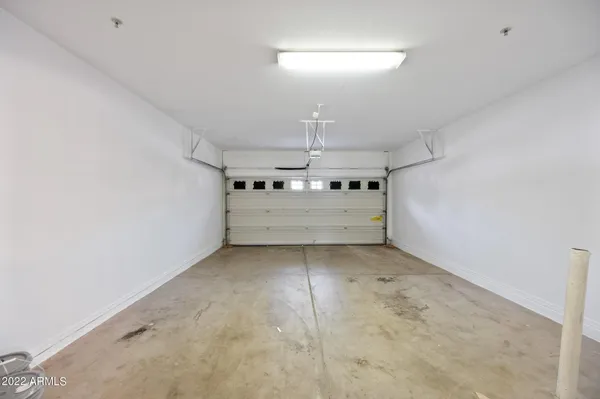 a big room with chandelier fan and windows