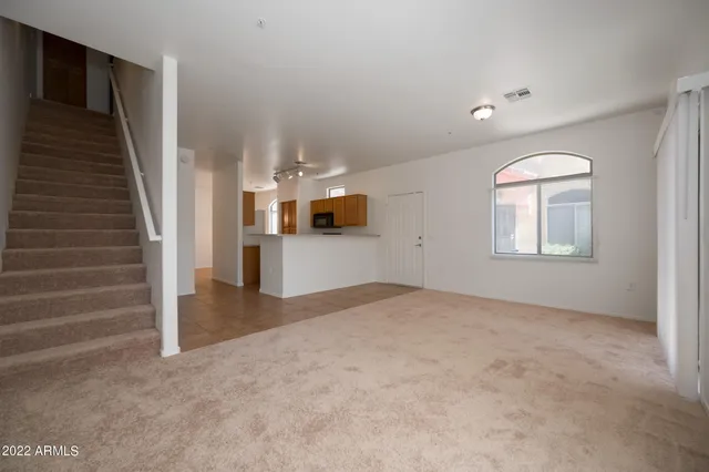 an empty room with windows and pillars in it