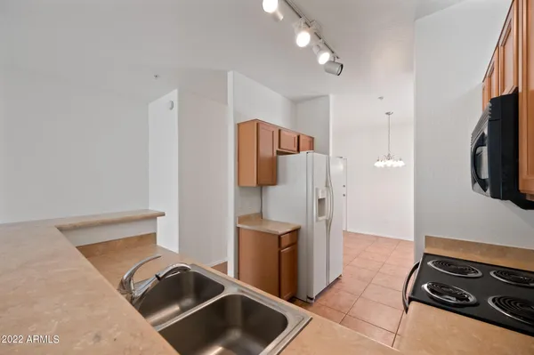 a kitchen with stainless steel appliances granite countertop a refrigerator and a stove