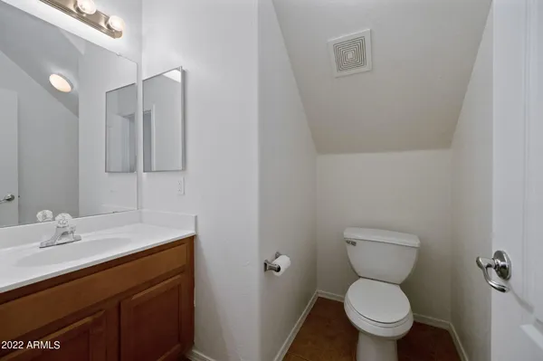 a bathroom with a sink toilet and a mirror