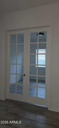 a view of a room with wooden floor