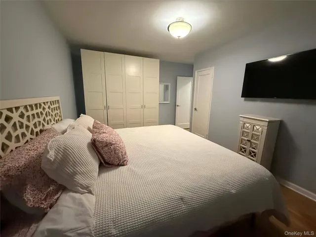 a bedroom with a large bed and a tv