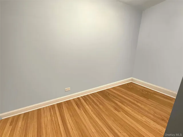 a view of a room with wooden floor and a window