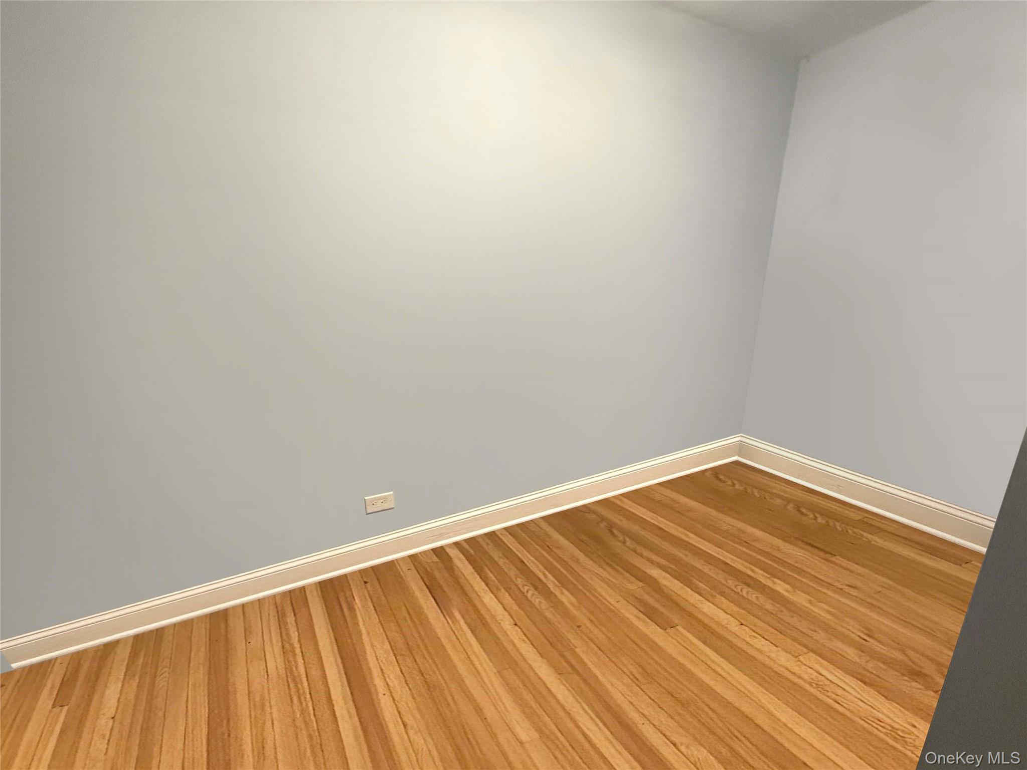76-10 34th Avenue, Unit 3T Queens, NY 11372 - Photo 12 of 16 a view of a room with wooden floor and a window