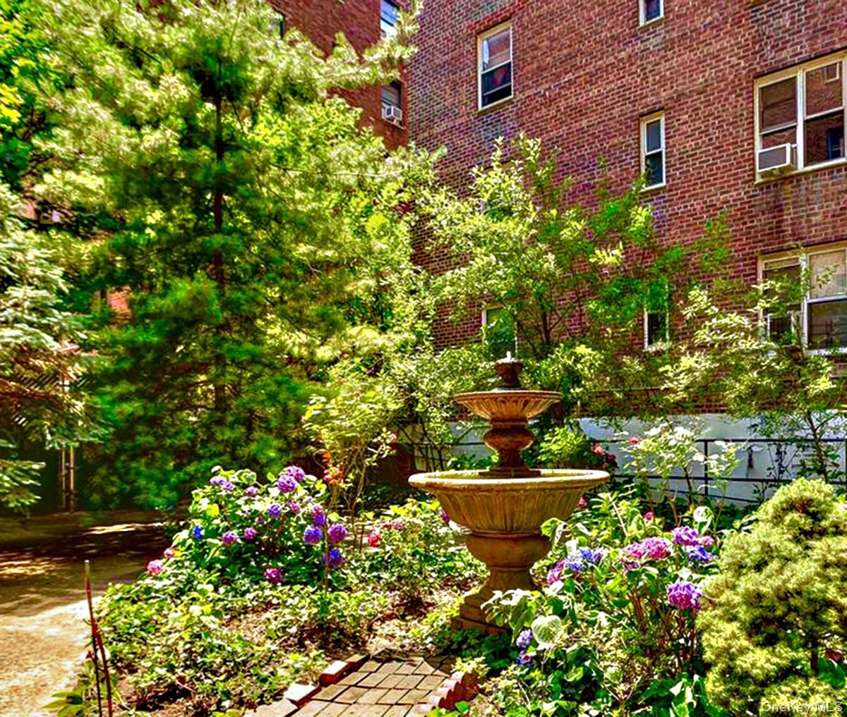 76-10 34th Avenue, Unit 3T Queens, NY 11372 - Photo 2 of 16 a view of a house with a flower garden