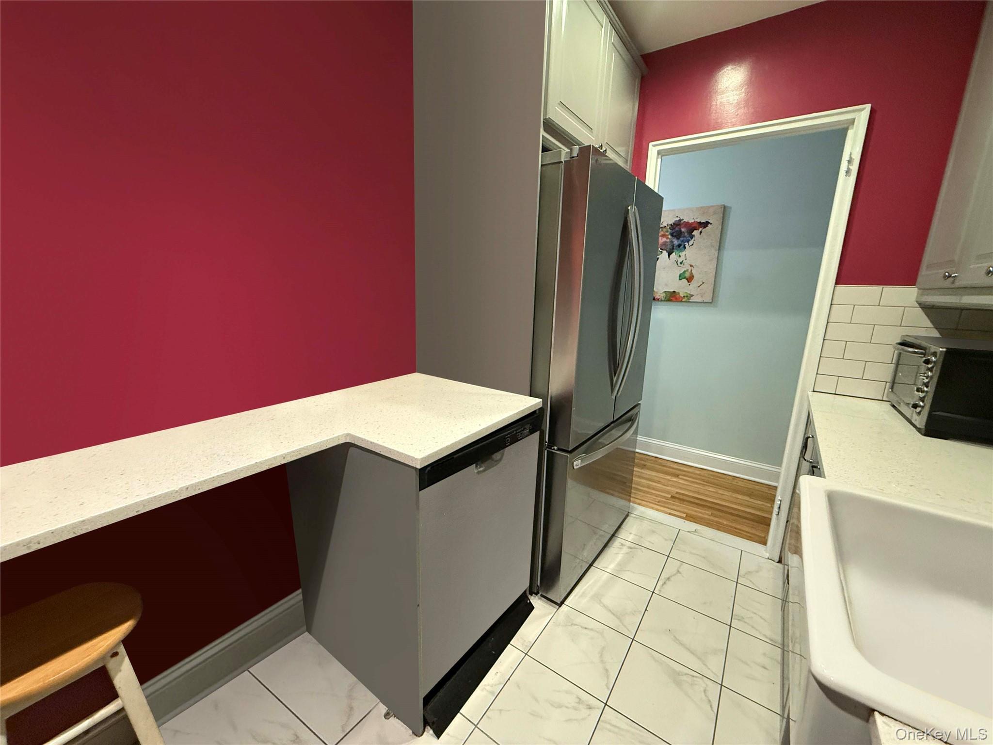 76-10 34th Avenue, Unit 3T Queens, NY 11372 - Photo 5 of 16 a kitchen with a sink and a refrigerator