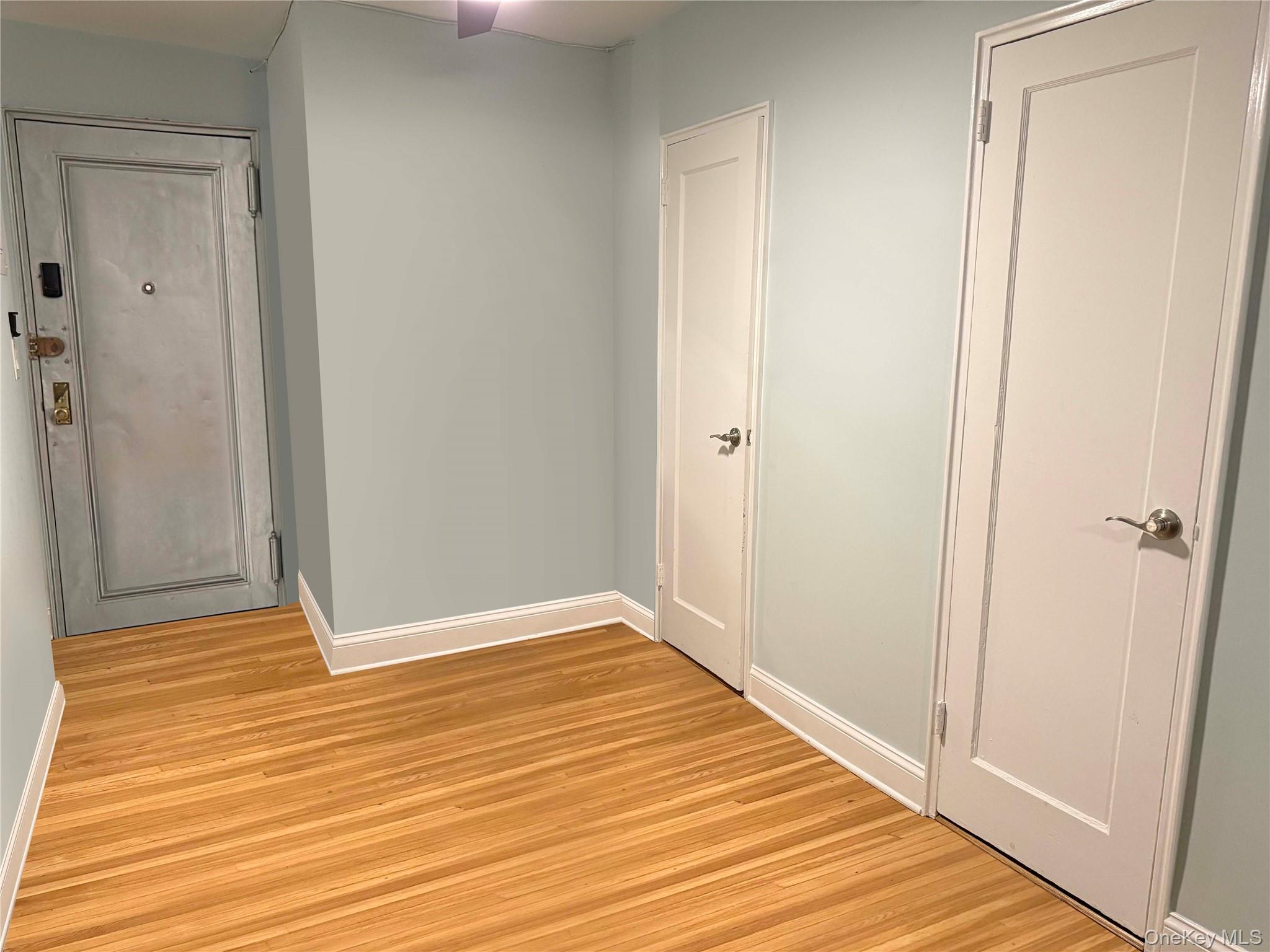 76-10 34th Avenue, Unit 3T Queens, NY 11372 - Photo 9 of 16 a view of an empty room with wooden floor