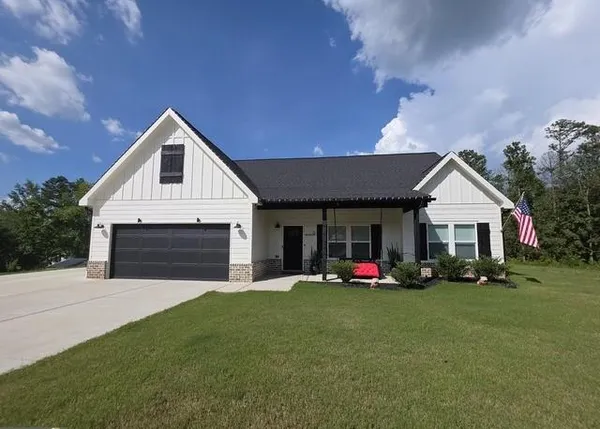 a front view of house with yard and green space