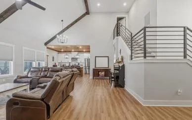 a living room with furniture a flat screen tv and a fireplace