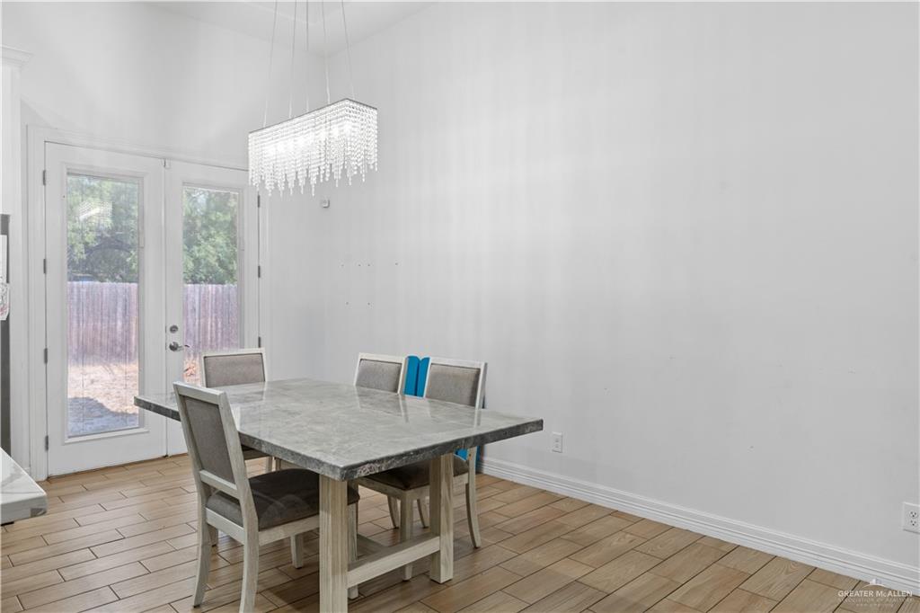 311 Seguin Loop Rio Grande City, TX 78582 - Photo 6 of 15 Rectangular crystal chandelier, wood-finish flooring, and double French doors