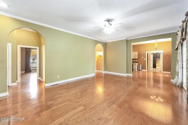 a view of a livingroom with wooden floor and chandelier