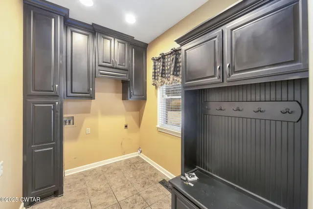 a view of a kitchen with wooden floor and cabinets