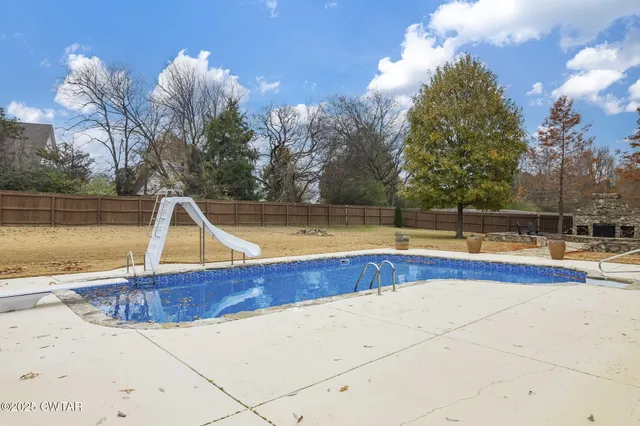 a view of a swimming pool with an outdoor space and seating area
