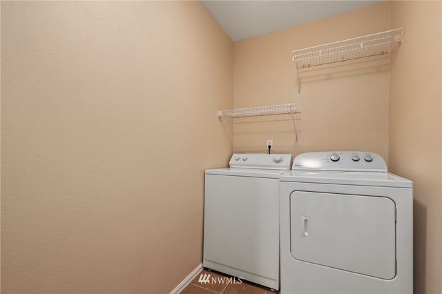 a view of a house with a door and wooden bench