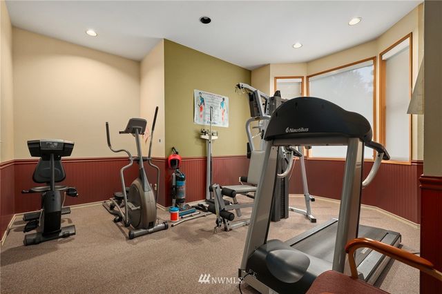 a view of house with backyard and chairs