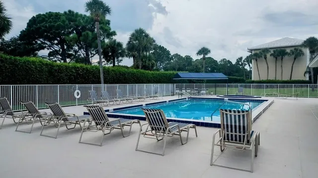 an outdoor sitting area with furniture and garden