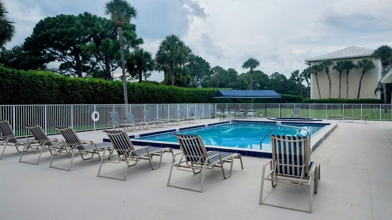 2791 Village Boulevard, Unit 105 West Palm Beach, FL 33409 - Photo 4 of 16 an outdoor sitting area with furniture and garden
