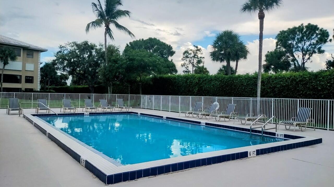 2791 Village Boulevard, Unit 105 West Palm Beach, FL 33409 - Photo 5 of 16 a view of a swimming pool with a chair