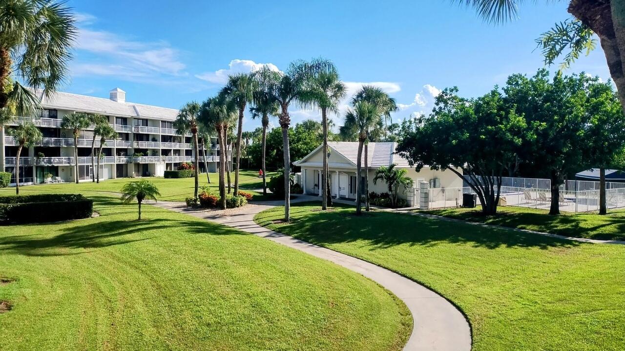 2791 Village Boulevard, Unit 105 West Palm Beach, FL 33409 - Photo 6 of 16 a view of a house with swimming pool and sitting area