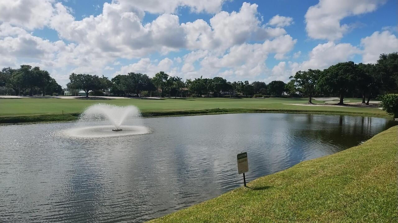 2791 Village Boulevard, Unit 105 West Palm Beach, FL 33409 - Photo 7 of 16 a view of a lake with a yard