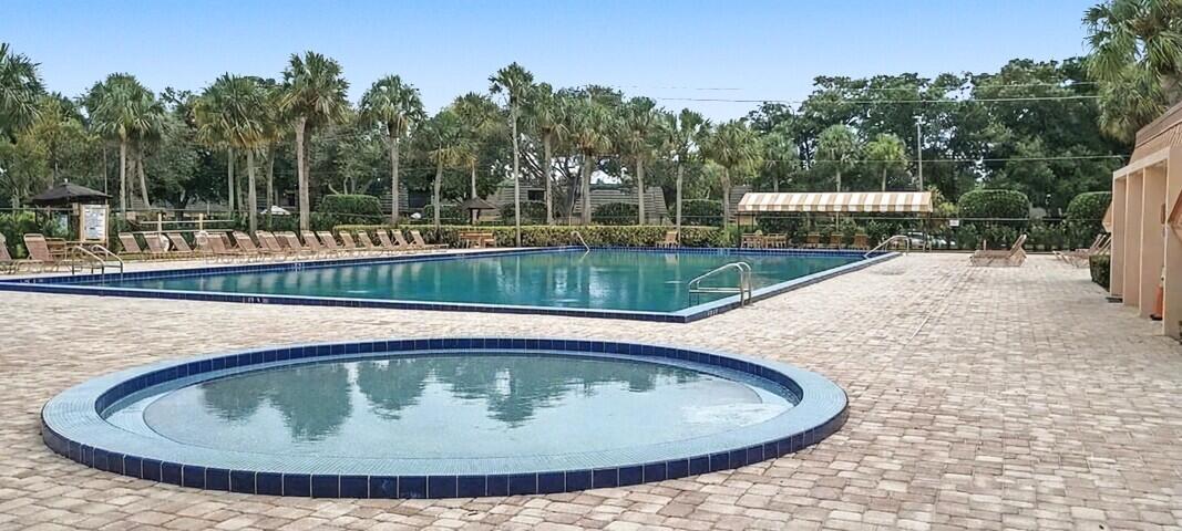 2791 Village Boulevard, Unit 105 West Palm Beach, FL 33409 - Photo 9 of 16 a view of swimming pool with a sitting space