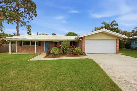 a front view of a house with a yard and porch