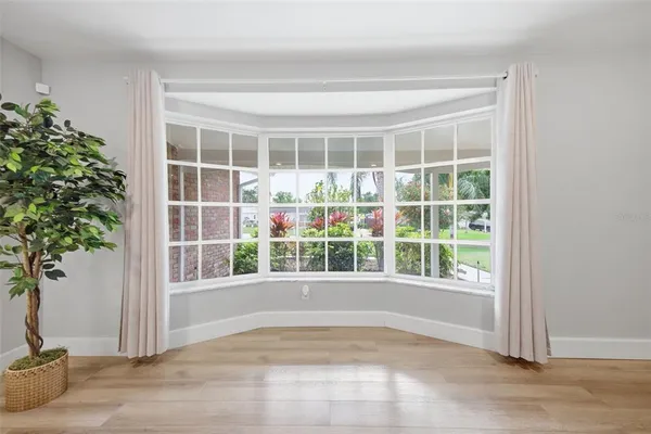 a view of empty room with windows and plants
