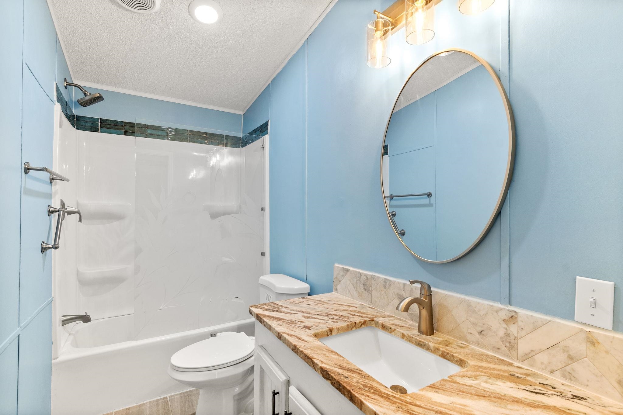 890 Kings Estate Road St. Augustine, FL 32086 - Photo 14 of 38 a bathroom with a granite countertop sink mirror vanity and toilet