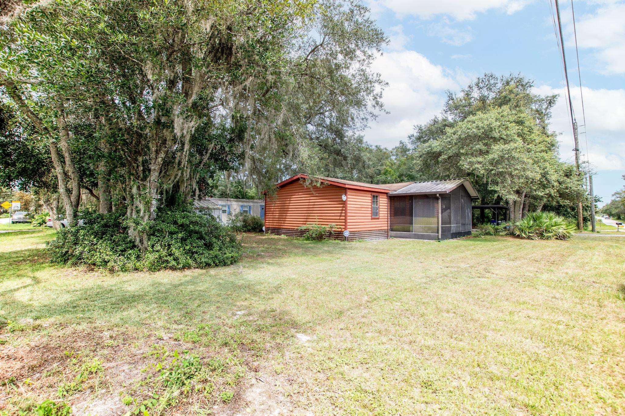 890 Kings Estate Road St. Augustine, FL 32086 - Photo 20 of 38 a view of a house with a yard and sitting area