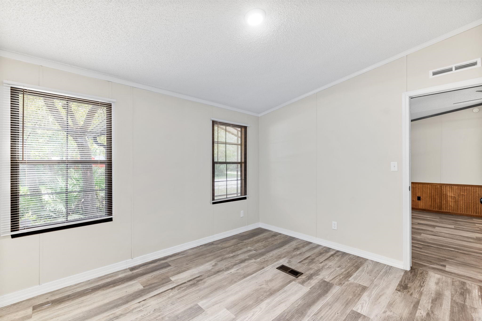 890 Kings Estate Road St. Augustine, FL 32086 - Photo 28 of 38 an empty room with wooden floor and windows