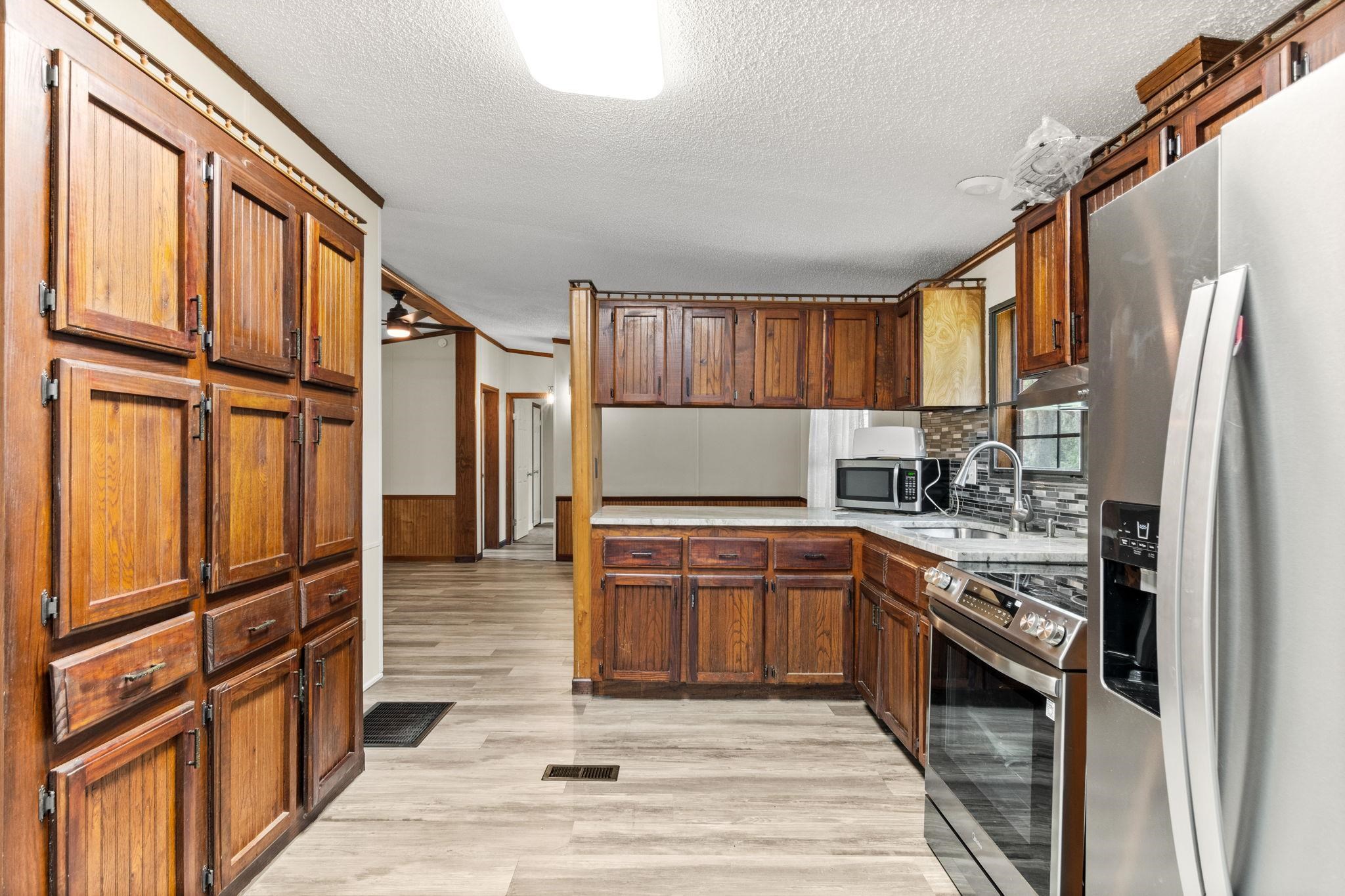 890 Kings Estate Road St. Augustine, FL 32086 - Photo 5 of 38 a kitchen with stainless steel appliances granite countertop a refrigerator stove and sink