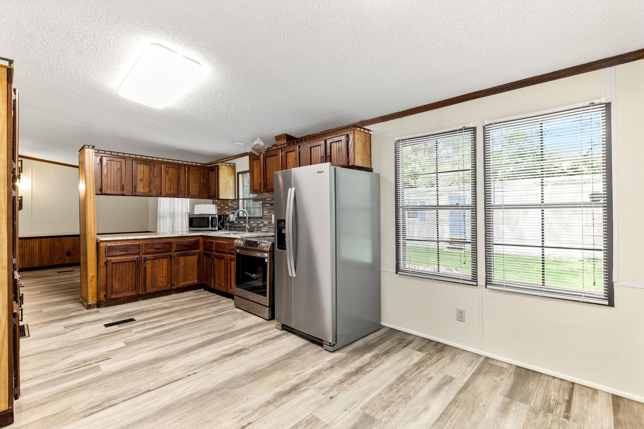 890 Kings Estate Road St. Augustine, FL 32086 - Photo 9 of 38 a kitchen with stainless steel appliances a refrigerator and a stove top oven