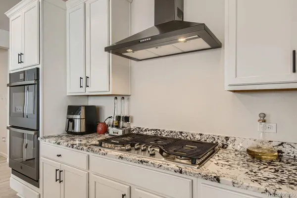 a stove top oven sitting inside of a kitchen