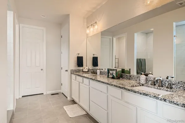 a bathroom with double sink and a mirror