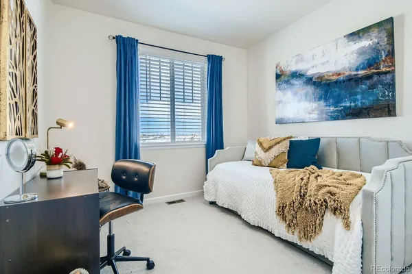 a bedroom with furniture and a window