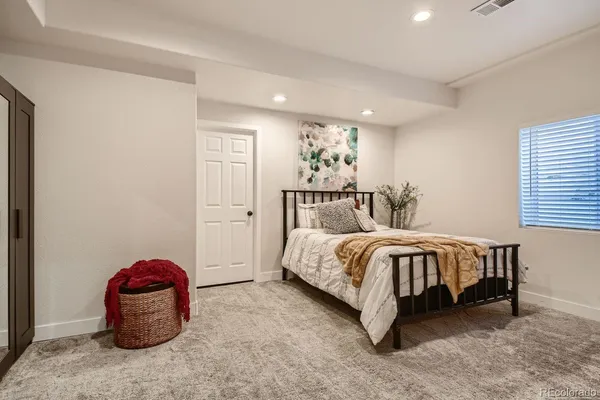 a bedroom with a bed and a chair