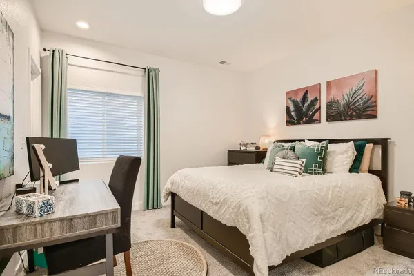 a bedroom with a bed and chair