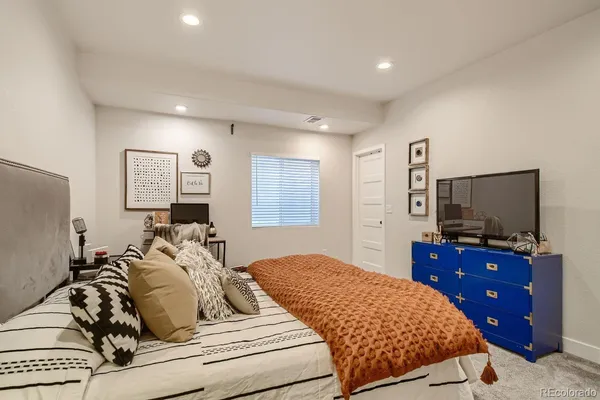 a bedroom with a bed and a flat screen television